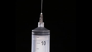 Making of fake breasts: filling of expander silicone breast implant with saline into twice its prescribed size