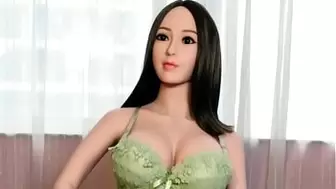 Sexy oriental love doll in green bikini with gigantic boobs ready for doggystyle