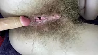 Hairy slut rides her wet huge clit twat with dildo in close up