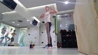 Alluring blonde teenie doing warmup at the gym